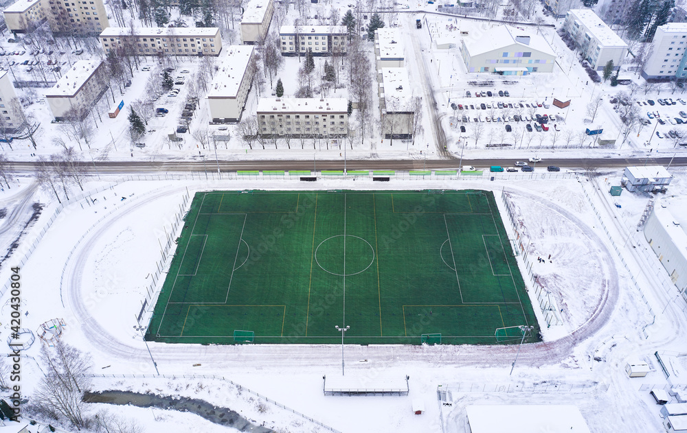 Aerial view of the outdoor football heated field in winter, Finland.