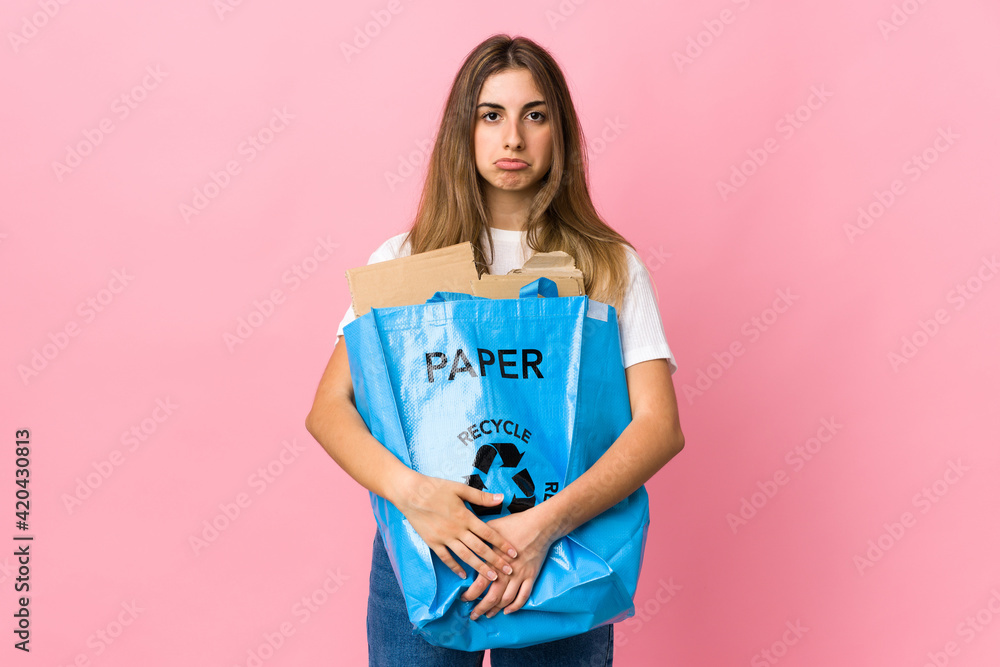 holding a recycling bag full of paper to recycle over isolated pink sad holding a recycling bag full of paper to recycle over isolated pink sad