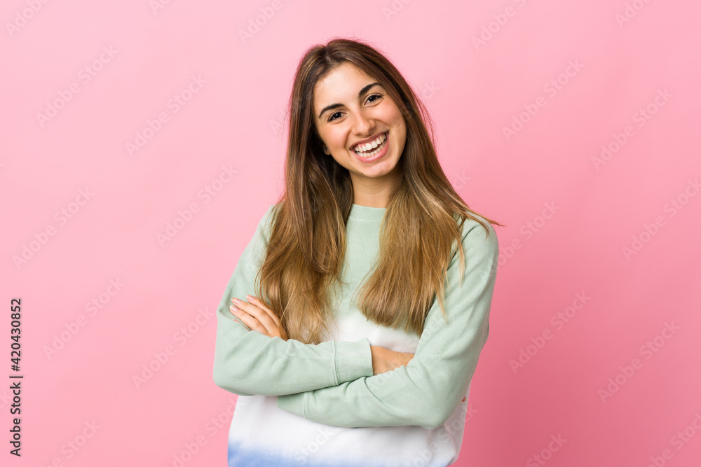 Young woman over isolated pink background keeping the arms crossed in frontal position Young woman over isolated pink background keeping the arms crossed in frontal position