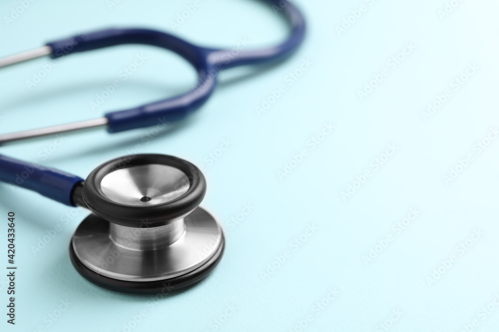 Stethoscope on light blue background, closeup. Space for text Stethoscope on light blue background, closeup. Space for text
