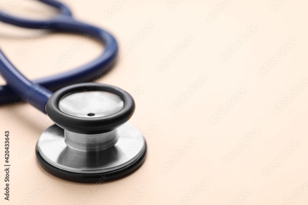 Stethoscope on beige background, closeup. Space for text Stethoscope on beige background, closeup. Space for text