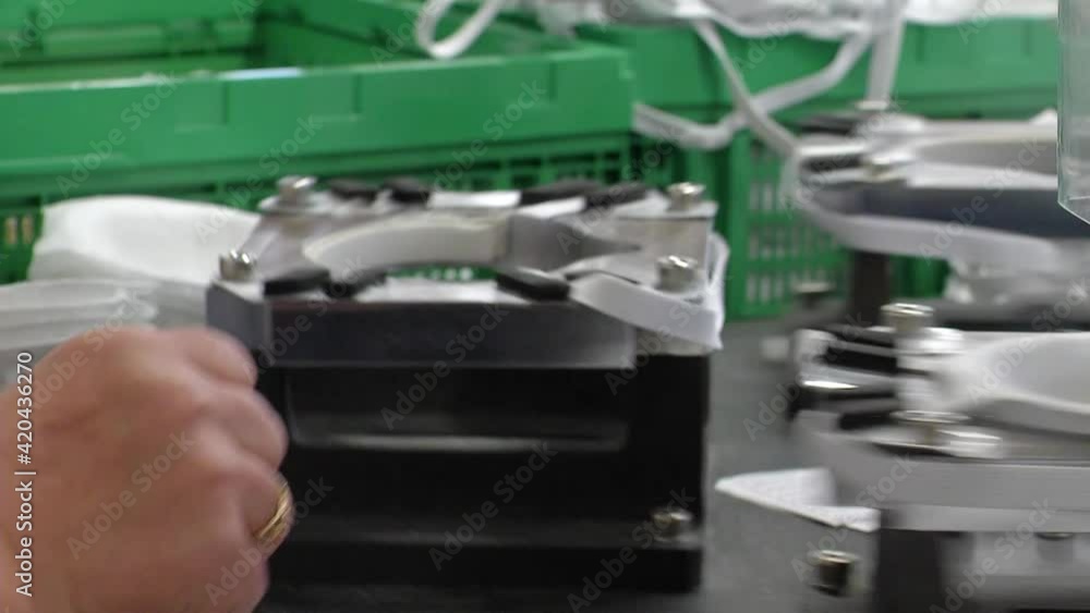 Fast motion of the face masks moving through the conveyor. Covid-19 prevention masks production process. Fast motion of the face masks moving through the conveyor. Covid-19 prevention masks production process.