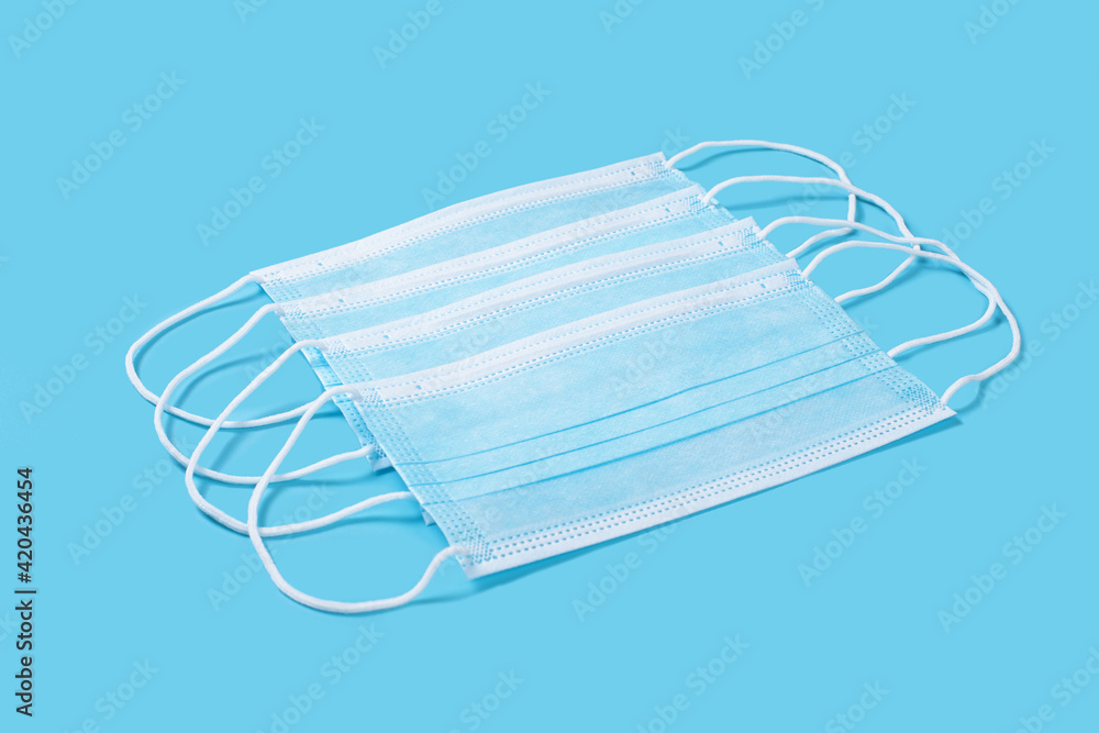 Some medical protective masks on blue background. Some medical protective masks on blue background.