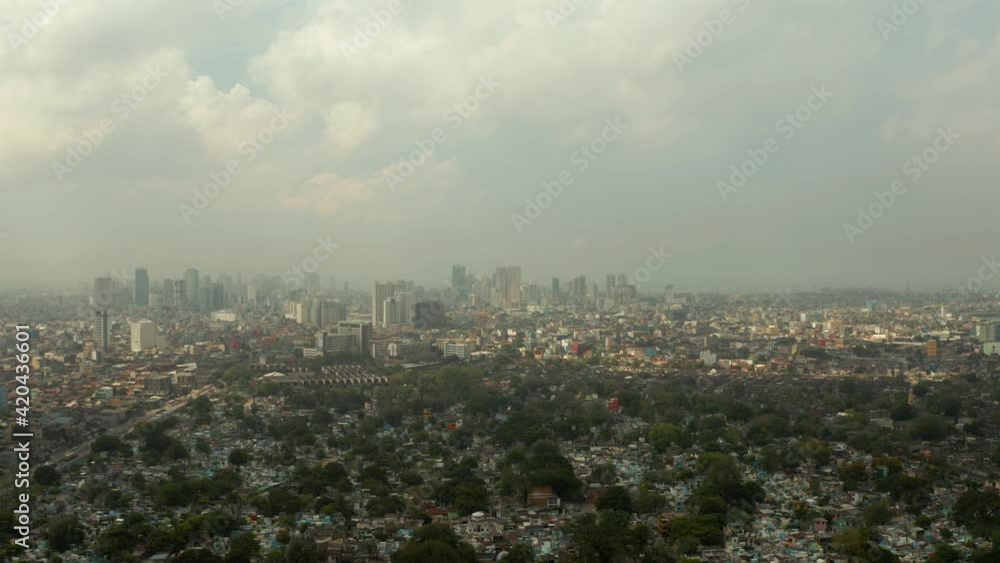 Aerial view of panorama of Manila North Cemetery with skyscrapers and business centers in a big city. Travel vacation concept Aerial view of panorama of Manila North Cemetery with skyscrapers and business centers in a big city. Travel vacation concept