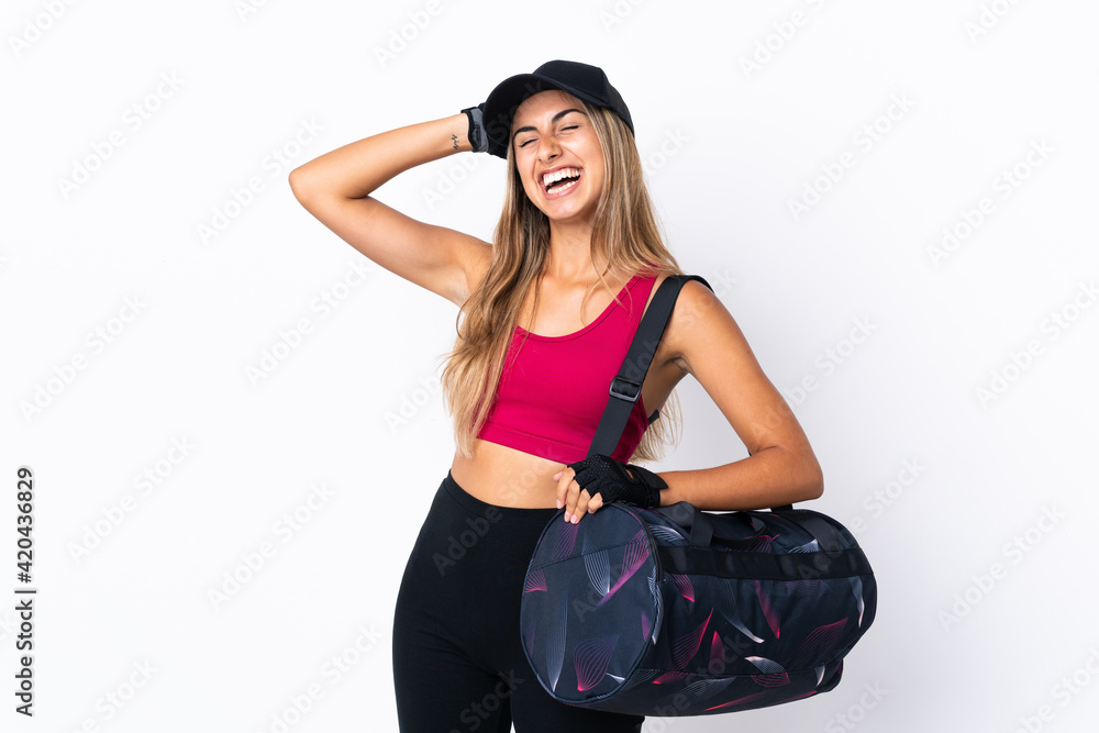 Young sport woman with sport bag over isolated white background smiling a lot Young sport woman with sport bag over isolated white background smiling a lot