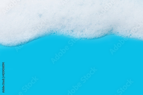 White foam flowing down. Background with copy space. Purity concept.