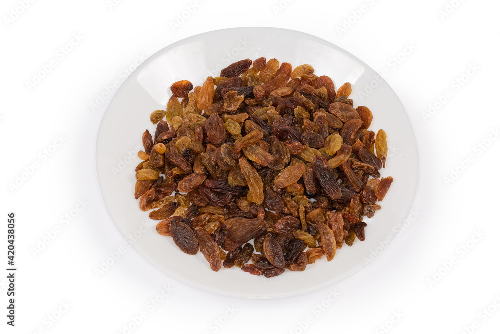 Dark yellow raisins on dish on a white background Dark yellow raisins on dish on a white background