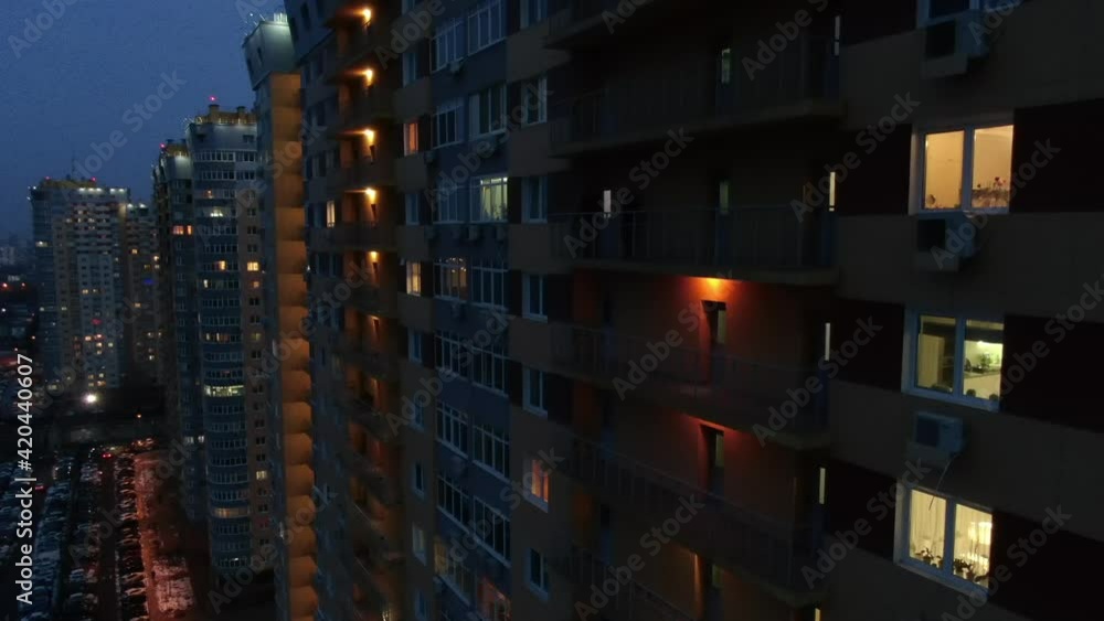 Night city. Residential buildings with glowing windows at night Night city. Residential buildings with glowing windows at night
