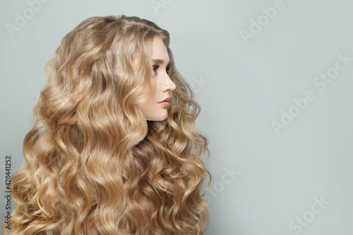 Healthy woman with long blonde hair on white, beautiful profile