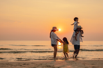 Happy family beach sunset. Children vacations. daughter mother father. parent and children enjoy the sunset sea on beach.Holiday travel concept, Summer vacations.