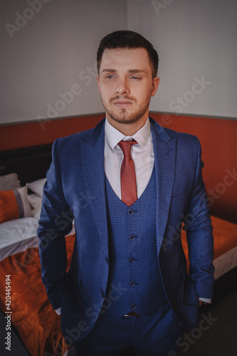 A stylish portrait of the groom preparing for the wedding ceremony.