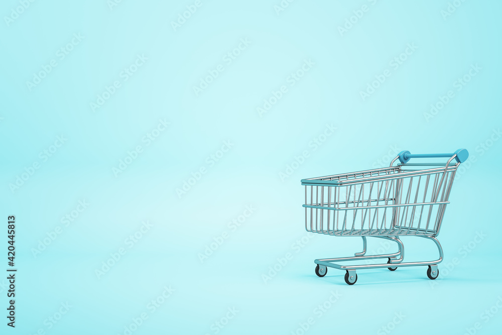 Online shopping concept with empty supermarket shopping cart on blue blank backdrop. Mockup