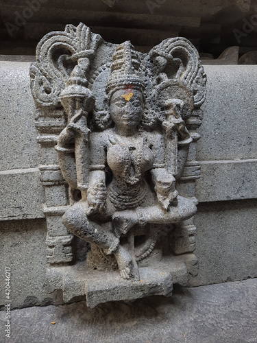 ancient sculpture of goddess in old hindu temple photo