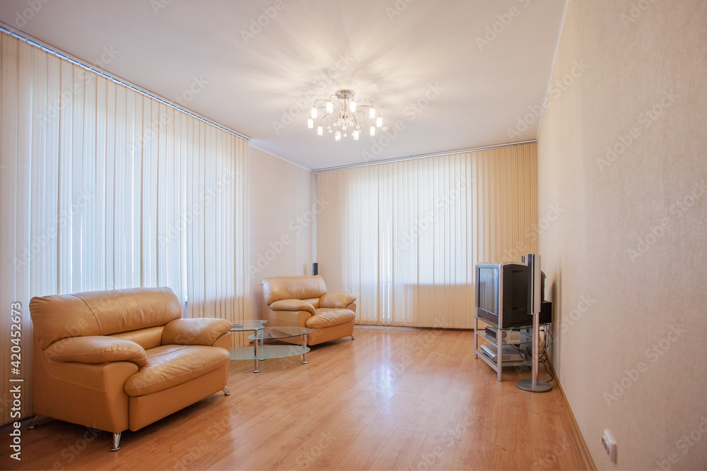 Living room has two leather armchairs and a beige sofa. Living room has two leather armchairs and a beige sofa.