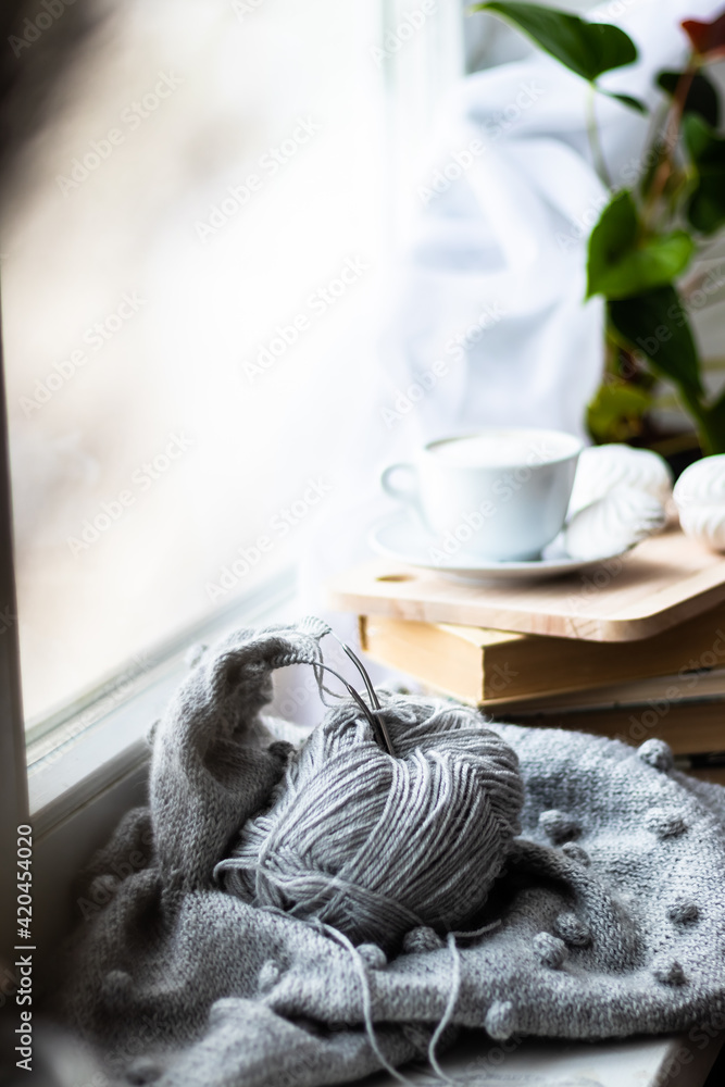 knitting on the window of a cup of coffee book hobby handmade.