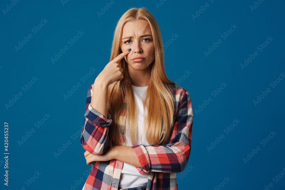Blonde young upset woman crying and looking at camera Blonde young upset woman crying and looking at camera