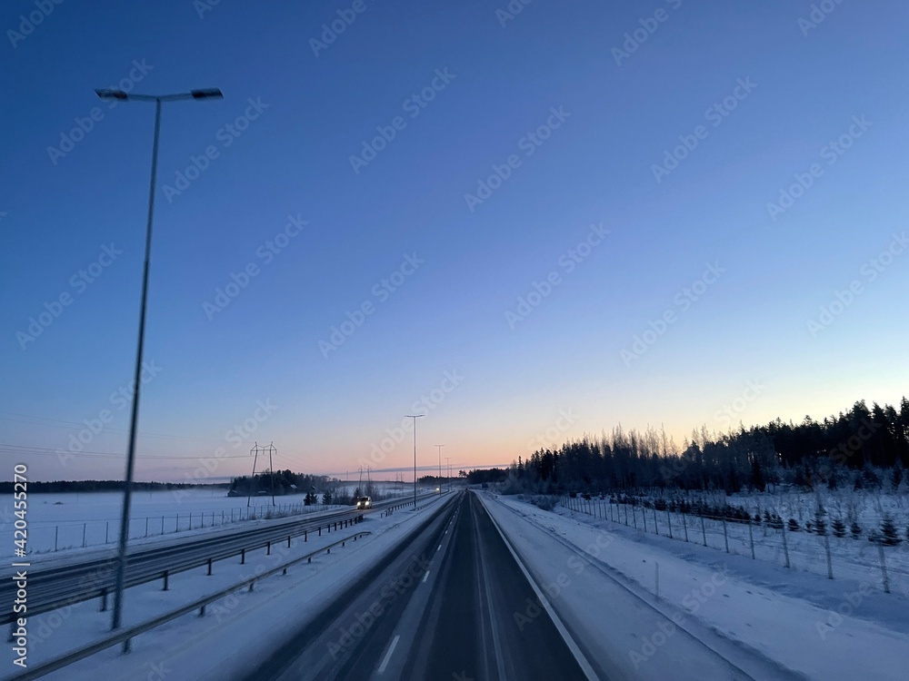 Highway with sunrise in Finland