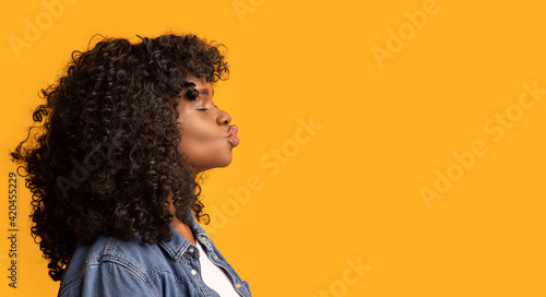 Side view of beautiful african american lady showing kissing lips