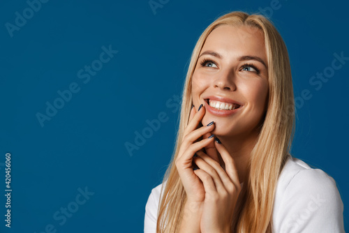 Blonde young happy woman smiling and looking upward