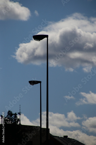 Street lamps against blue sky