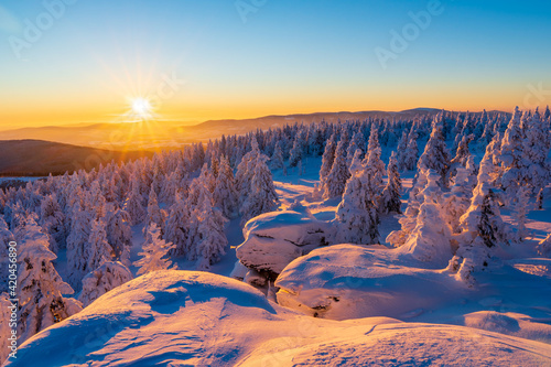Fantastic winter landscape in snowy mountains glowing by morning sunlight. Dramatic wintry scene with frozen snowy trees at sunrise. Christmas holiday background. Vozka Jeseniky, czech