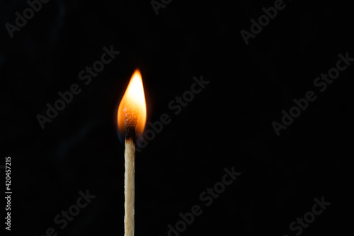 Burning match on a black background. Macro photography of a burning match. Burning match. 