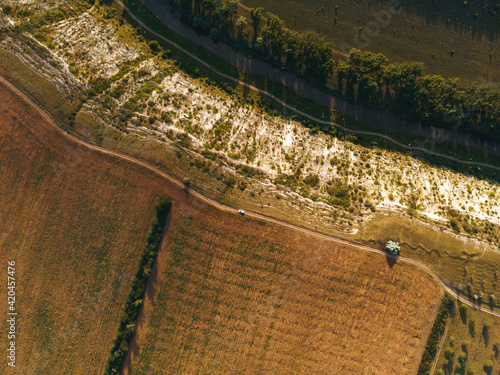 drone view on white car on road on hill