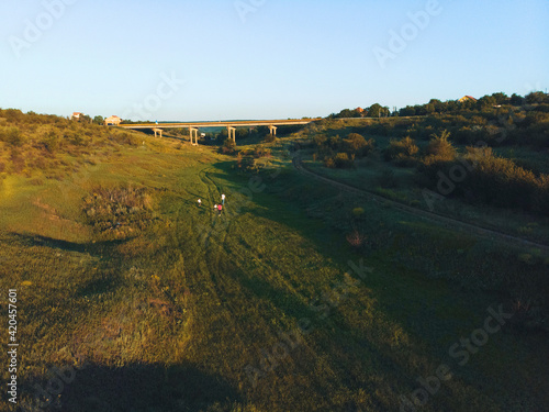 family walking away under bridge