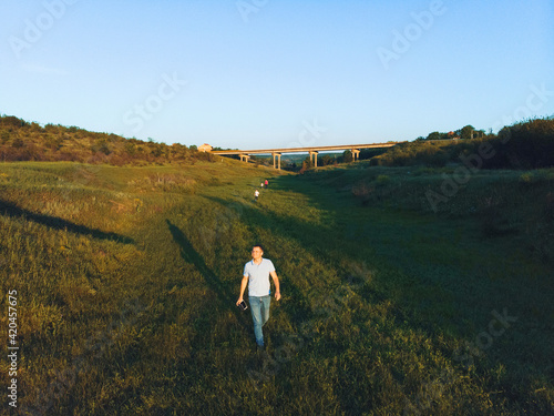 family walking under bridge