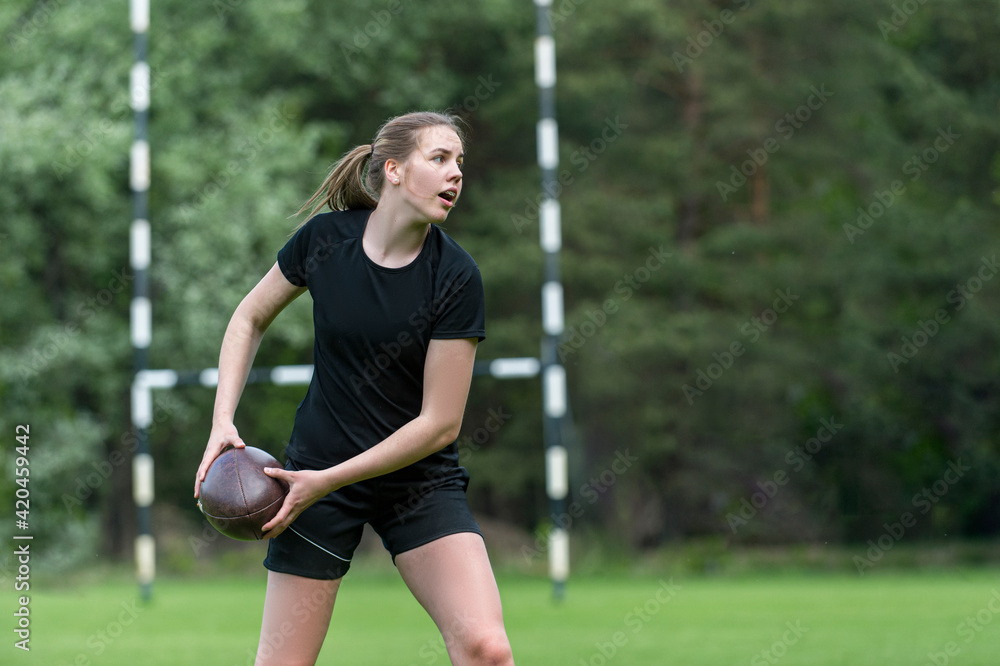 Girl playing rugby together outside in summer. Woman sport concept