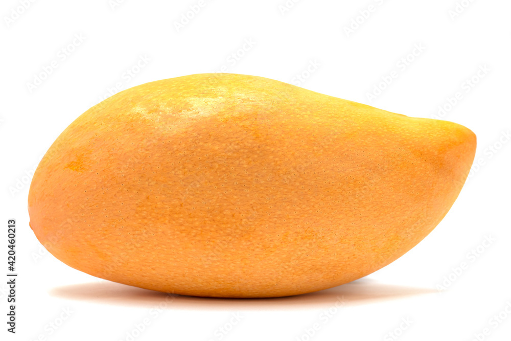 A yellow ripe mango that is distinguished from the white background.
