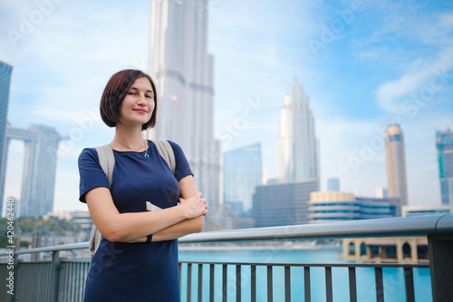 Young beautiful woman enjoying the view of Dubai downtown. Free Download Young beautiful woman enjoying the view of Dubai downtown. - GFXLoad