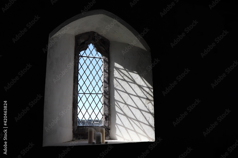 Church Window with Candles in Whitchurch in Pembrokeshire, Wales, UK