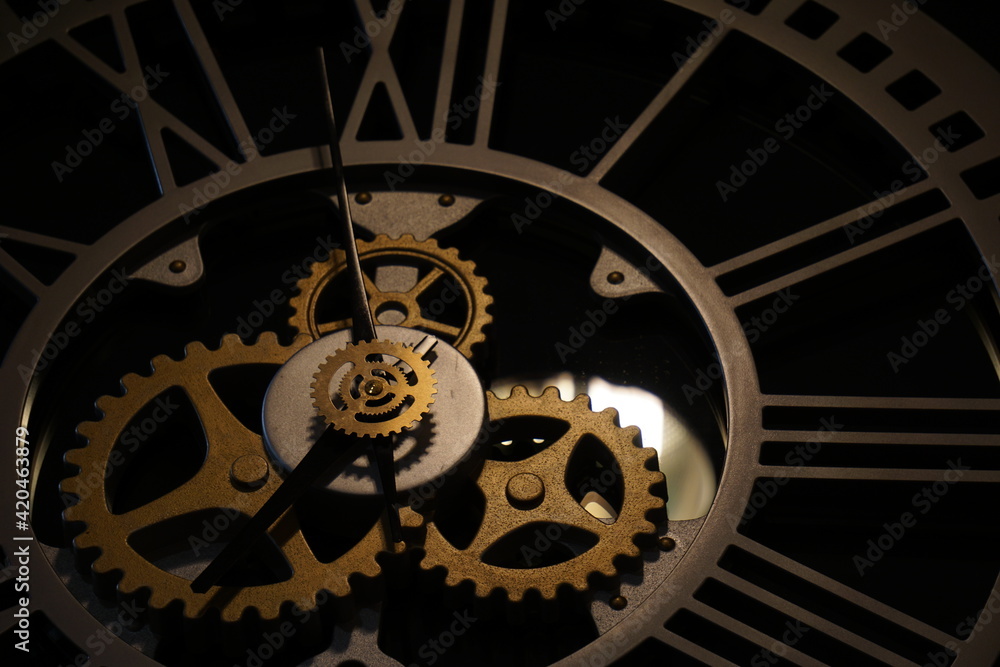 Old watch mechanism in the dark. Clock hands as symbol of time management.