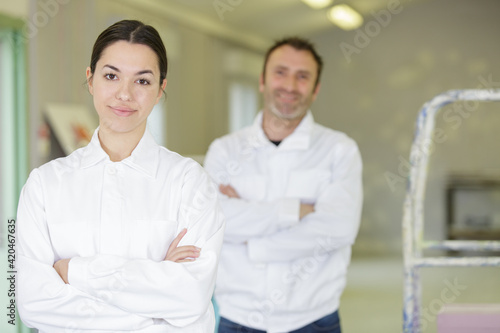 two workers are smiling at the camera