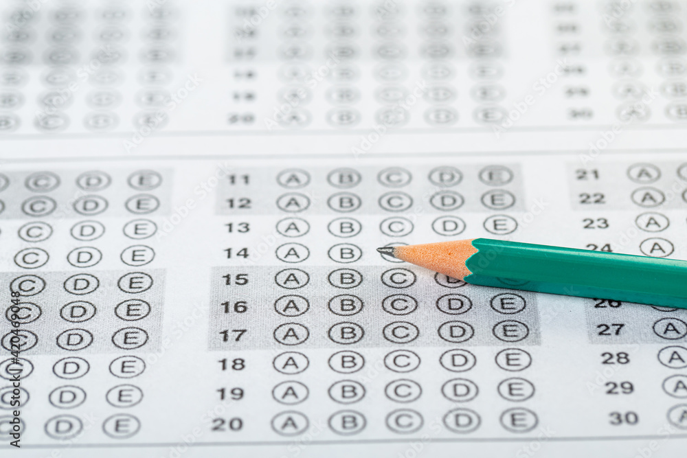 testing in exercise and exam paper. computer sheet with pencil in school test room, education concept. filling in answers in pencil testing in exercise and exam paper. computer sheet with pencil in school test room, education concept. filling in answers in pencil