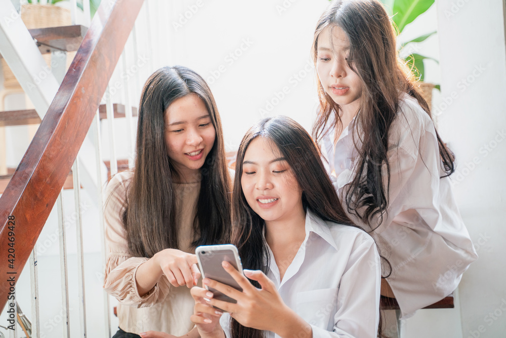 Business women group use smartphone social media connection in home office Business women group use smartphone social media connection in home office