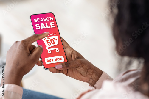 Black lady making online shopping, using mobile application