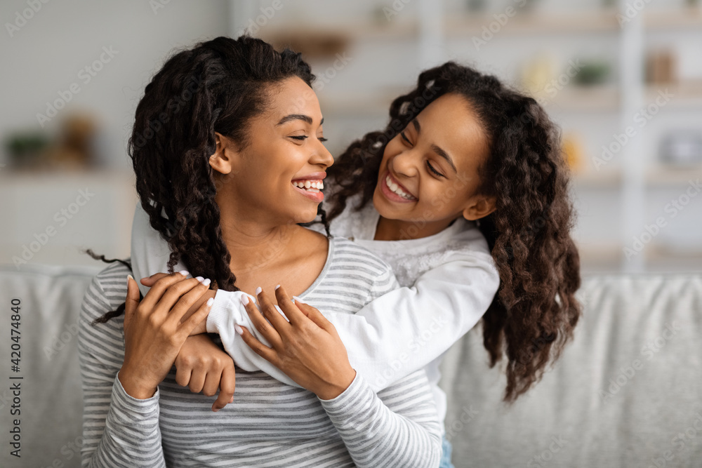 © Prostock-studio - Cheerful african american mother and daughter having fun at home