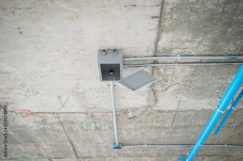 Billede på lærred Electrical conduit for cable routing between electrical distribution panel with Galvanized electrical junction box and Pipe of electricity line installed in buildings