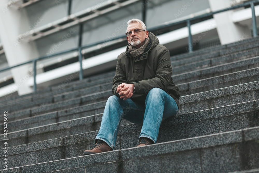Loneliness in old age. The senior man sits and reflects. Sadness and depression. Loneliness in old age. The senior man sits and reflects. Sadness and depression.
