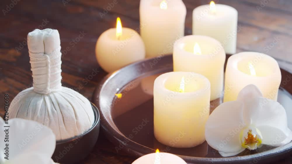 Spa background. Towel, candles, flowers, massaging stones and herbal balls. Massage, oriental therapy, wellbeing and meditation. Spa background. Towel, candles, flowers, massaging stones and herbal balls. Massage, oriental therapy, wellbeing and meditation.