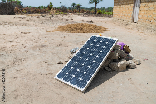 Solar panel resting on rocks in West Africa