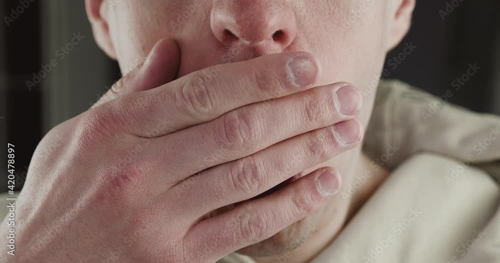 Close up mouth of a shocked man in fright covers his mouth with his hands, frightened by sudden bad news, macro shot Close up mouth of a shocked man in fright covers his mouth with his hands, frightened by sudden bad news, macro shot