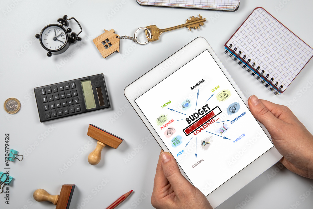 BUDGET. Planning, Saving, Investment and Control concept. Digital tablet and desk with office supplies BUDGET. Planning, Saving, Investment and Control concept. Digital tablet and desk with office supplies