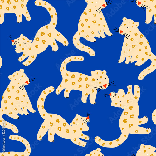 Vector seamless pattern with cute jaguars or leopards   on blue background. Tropical animals. Fashionable fabric design for kids clothing.