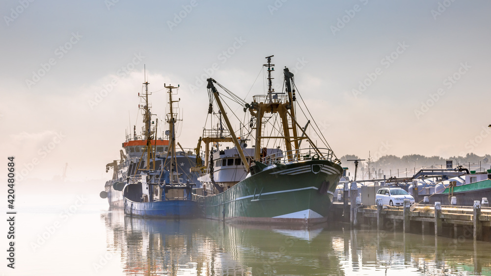 Modern fishing ships in hazy weather haringvliet