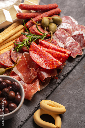 Charcuterie board with chorizo, jamon, pork sausage with pepper, fuet, cheese