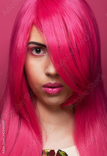 Fashion and beauty concept: Beautiful fashionable model female with pink hair