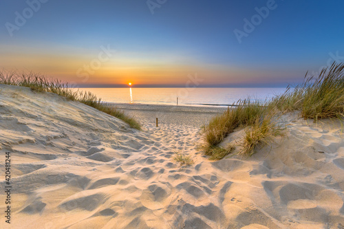 Fotografering Sunset View over ocean from dune in Zeeland